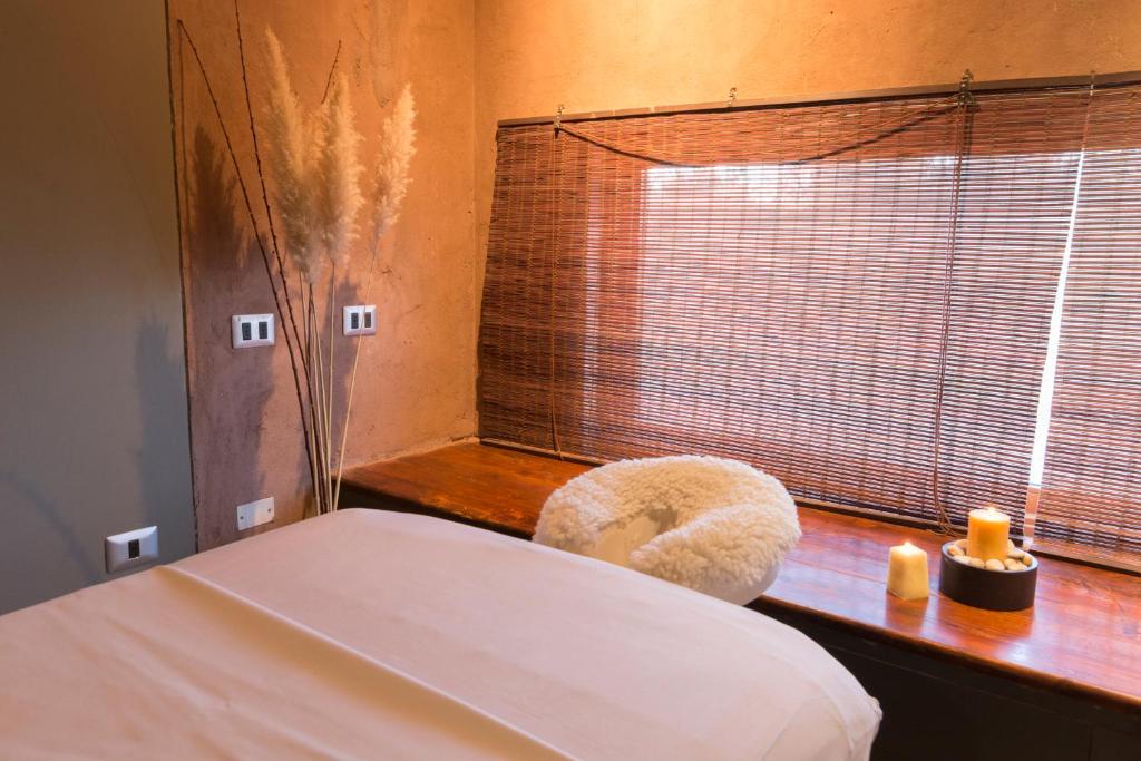 Uma cama ou camas num quarto em Hotel Cumbres San Pedro de Atacama