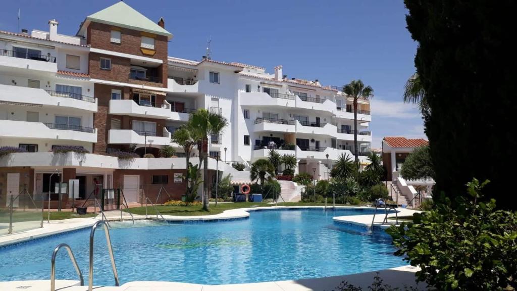 a swimming pool in front of a building at Apartment Riviera del Sol - Seaview in Mijas Costa