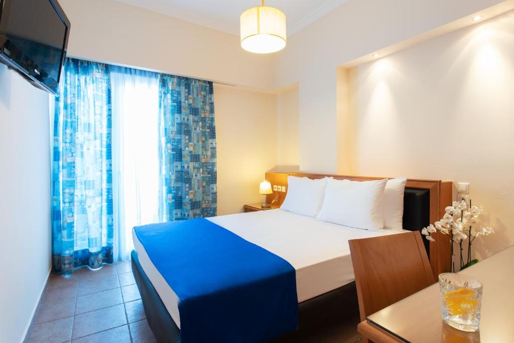 Postel nebo postele na pokoji v ubytování Pantheon City Hotel