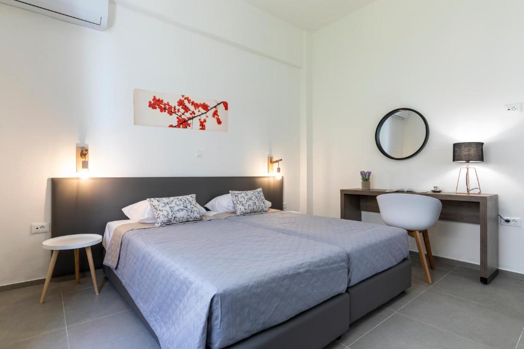 a bedroom with a bed and a desk and a mirror at Rose Central Master Bedroom Apartment in Rhodes Town