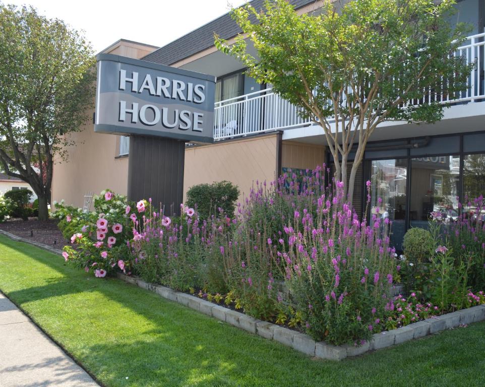 a sign for a harris house with flowers in front of it at Harris House by the Beach in Ocean City