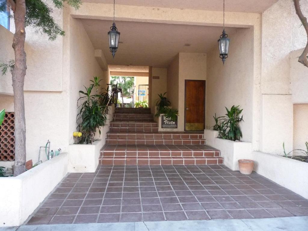 a building with stairs and potted plants at Catalina's Got Cart Condo in Avalon