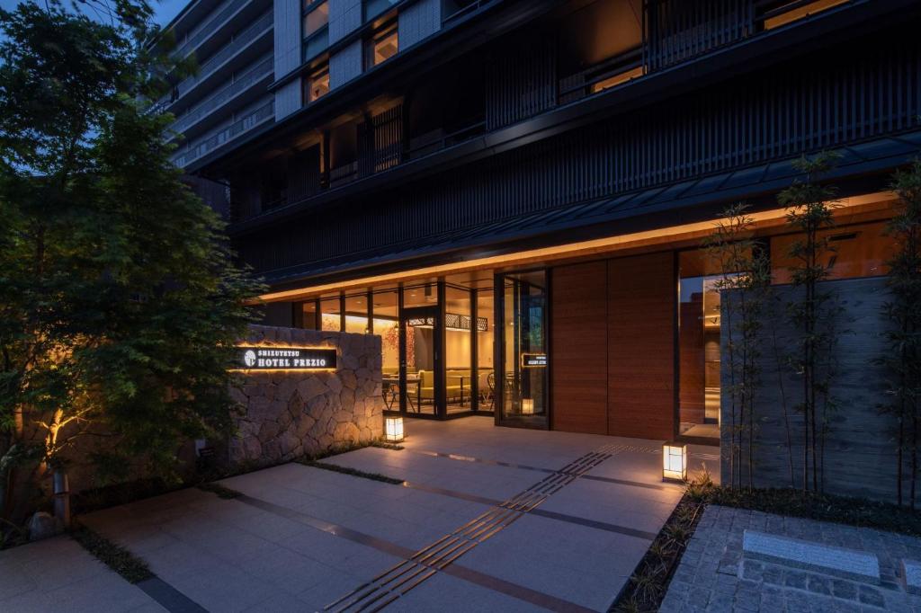 an external view of a building with lights at Shizutetsu Hotel Prezio Kyoto Karasumaoike in Kyoto