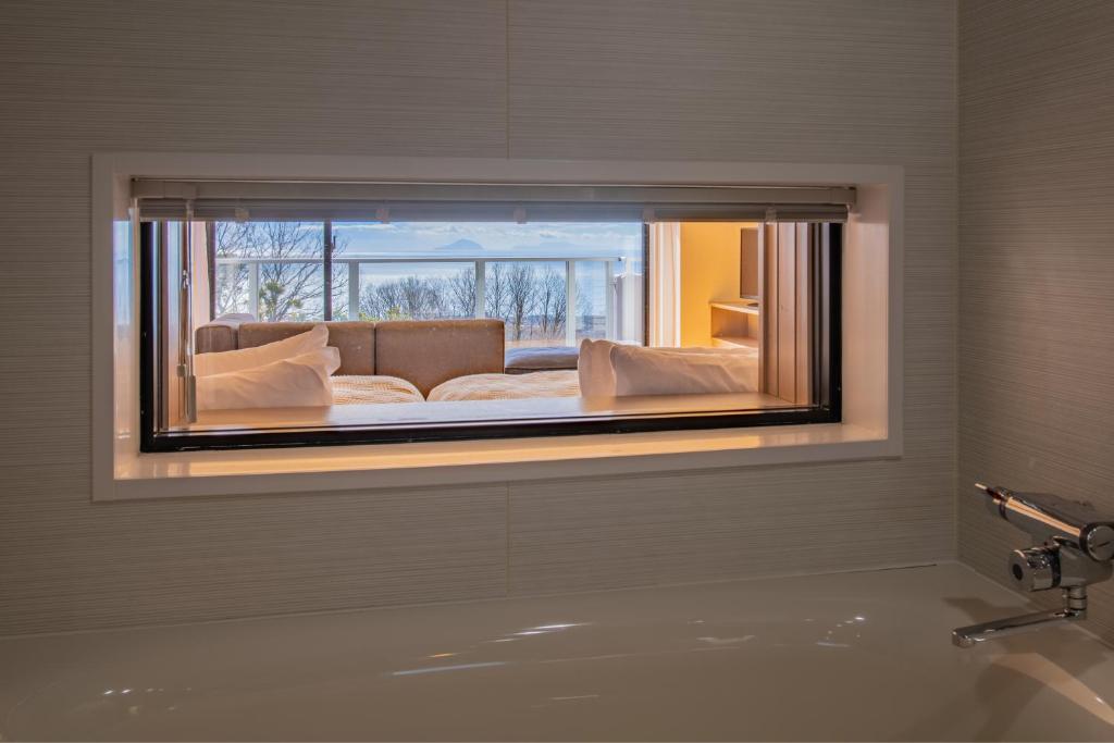 Postel nebo postele na pokoji v ubytování the salon 伊豆高原 Hotels & Resort