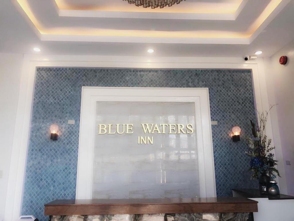a store window with a blue waters inc sign on it at Blue Waters Inn Coron Palawan in Coron