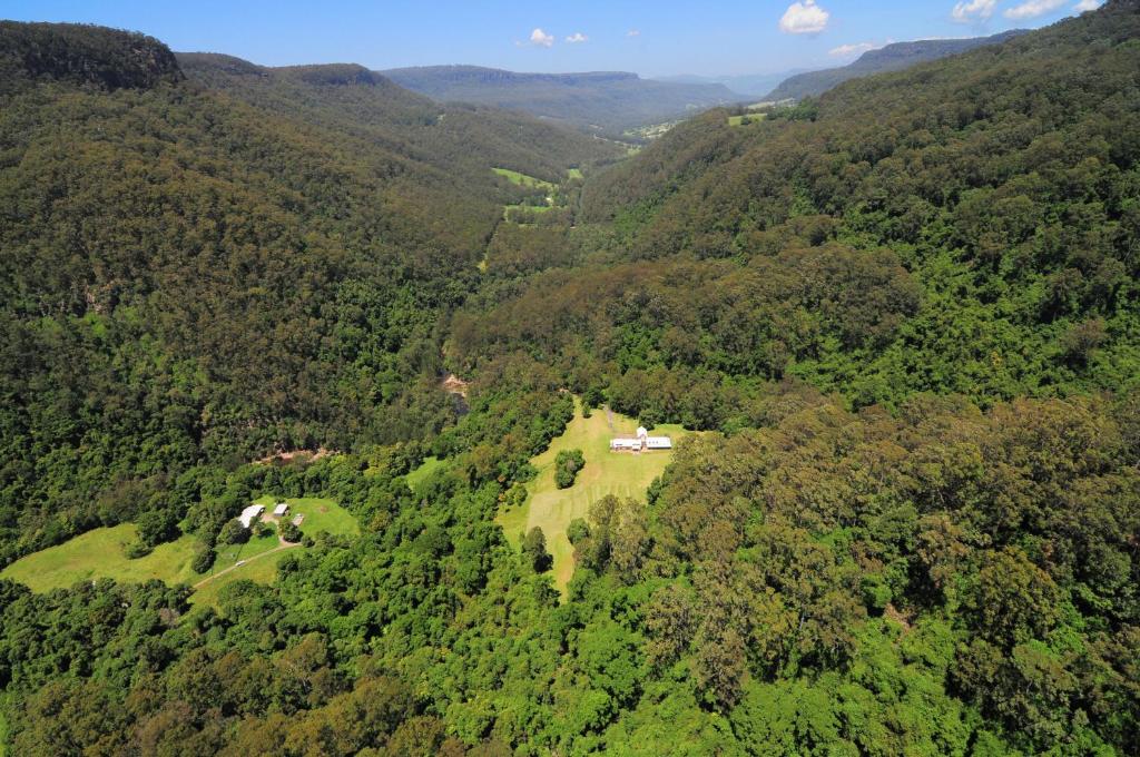 an aerial view of a farm in the middle of a forest at Yeola Lush location with river access in Upper Kangaroo River