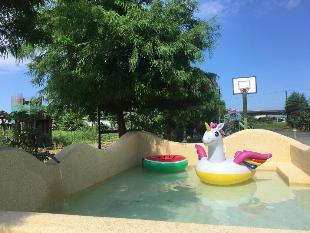 a small pool of water with a toy horse in it at Muho B&amp;B in Dongshan