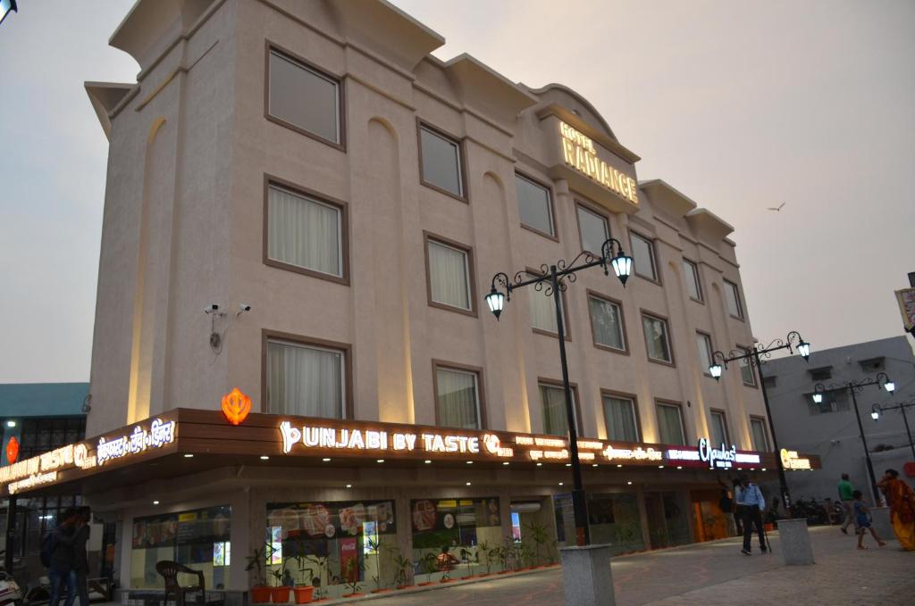 a large building with a sign on the front of it at Hotel Radiance in Bareilly