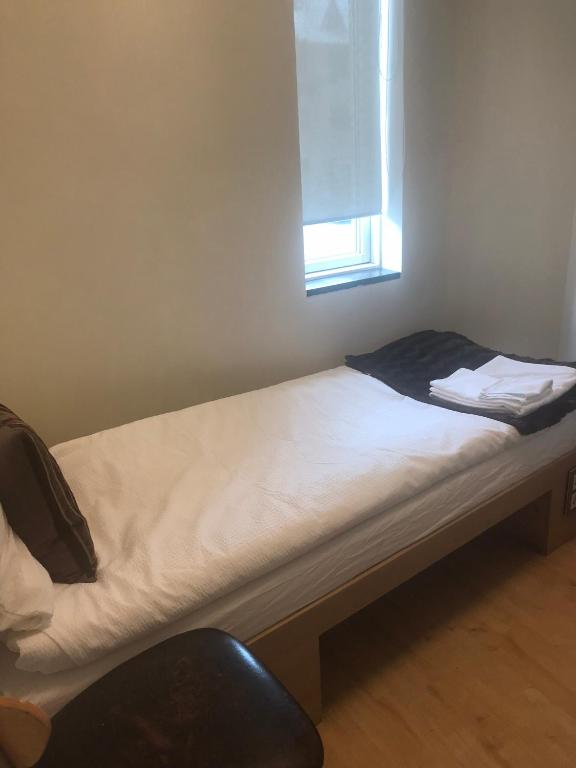 Postel nebo postele na pokoji v ubytování REK Inn
