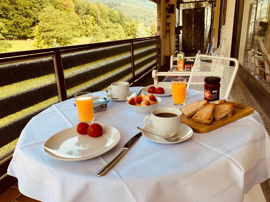 a table with a breakfast of toast and coffee and orange juice at Black Forest Apartment in Bad Herrenalb