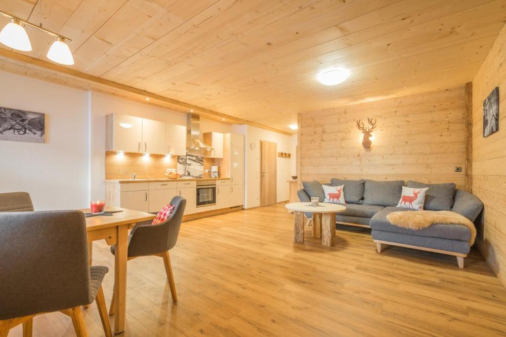 a living room with a couch and a table at Landhaus Panorama in Bad Hindelang