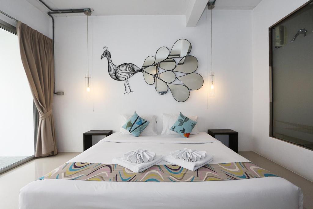Postel nebo postele na pokoji v ubytování The Nest Resort Patong
