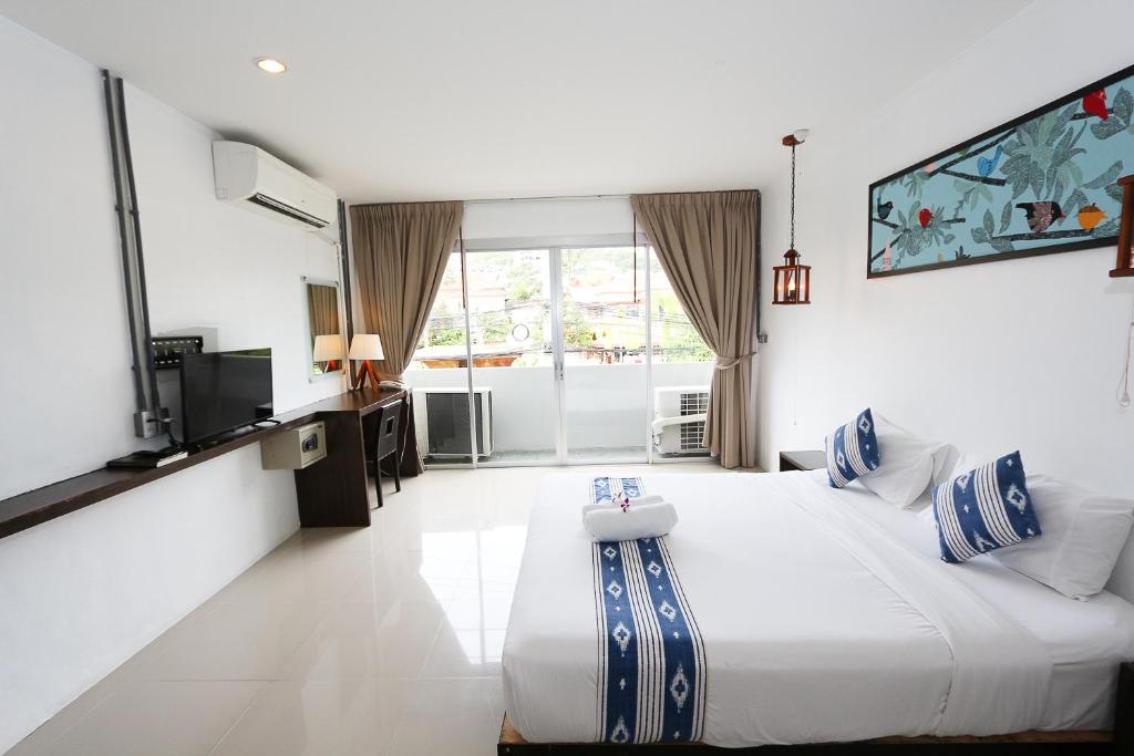 Postel nebo postele na pokoji v ubytování The Nest Resort Patong