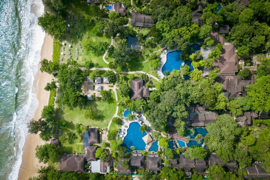 an overhead view of a beach with blue water at Khaolak Merlin Resort in Khao Lak