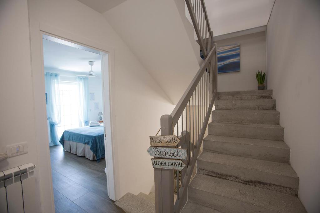 a staircase leading to a bedroom with a bed at Laura e Christian - Rooms in Grado