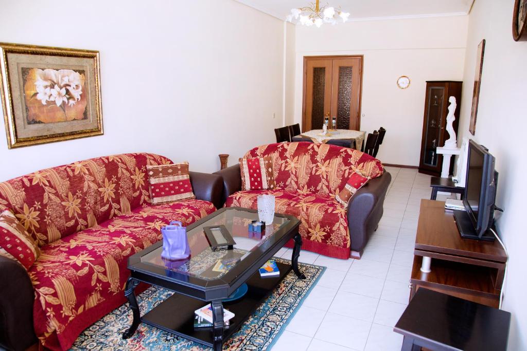 a living room with a couch and a table at Comfortable House with Warm Hospitality in Katerini