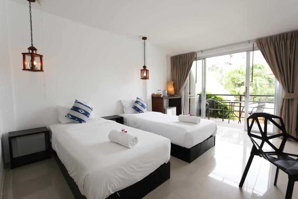 Postel nebo postele na pokoji v ubytování The Nest Resort Patong