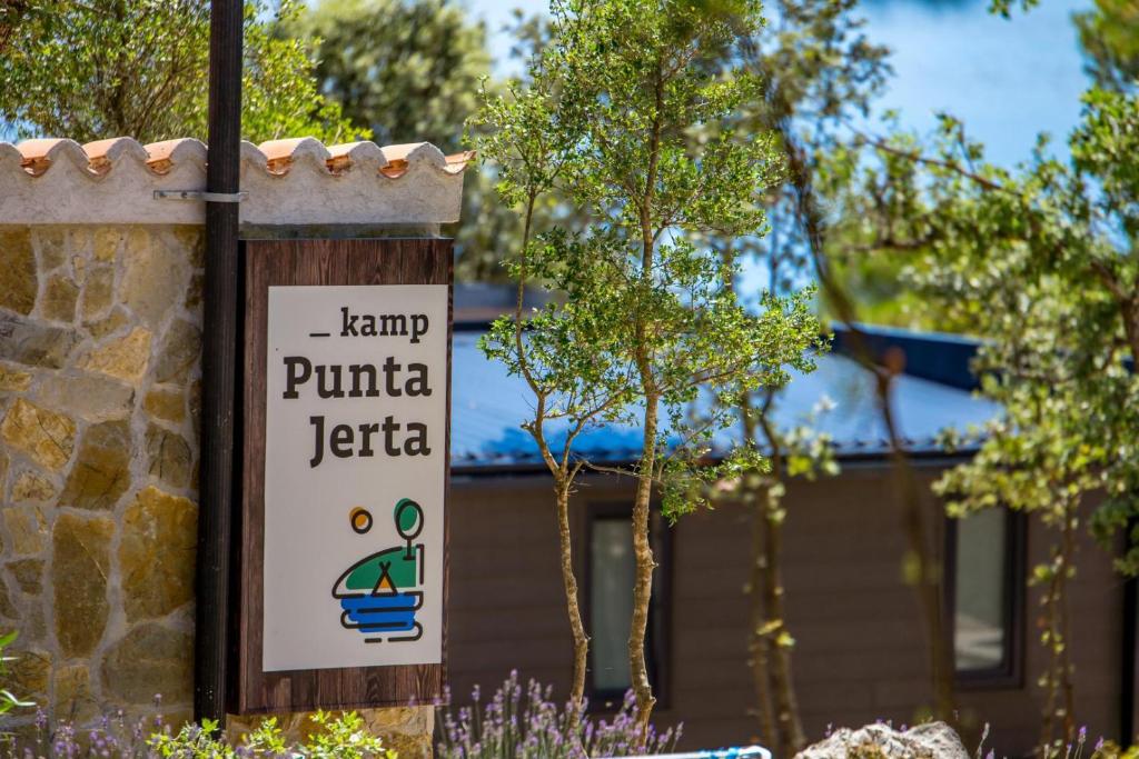 a sign for a park in front of a building at Kamp PUNTA JERTA in Krk