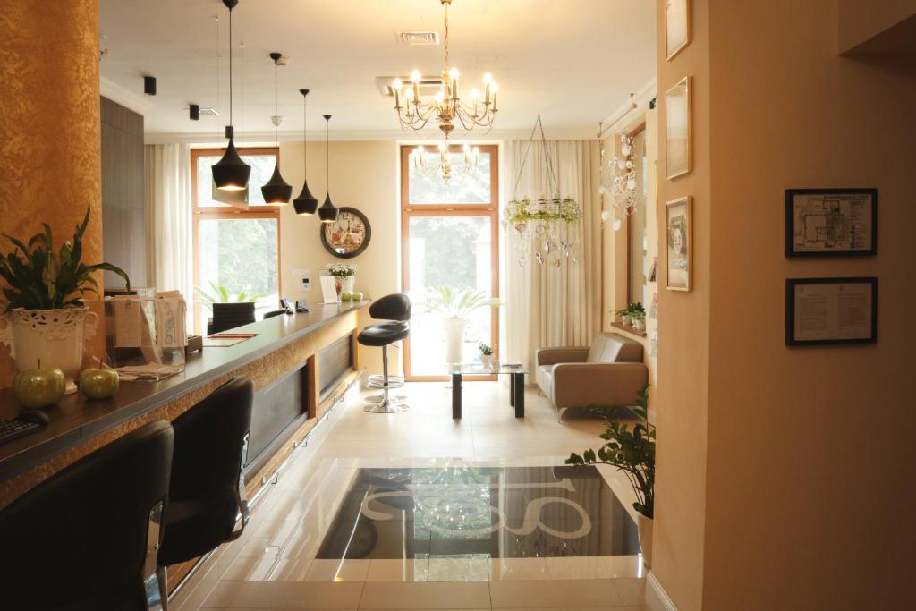 a living room with a bar and a living room with a table at Hotel Gal in Tarnów