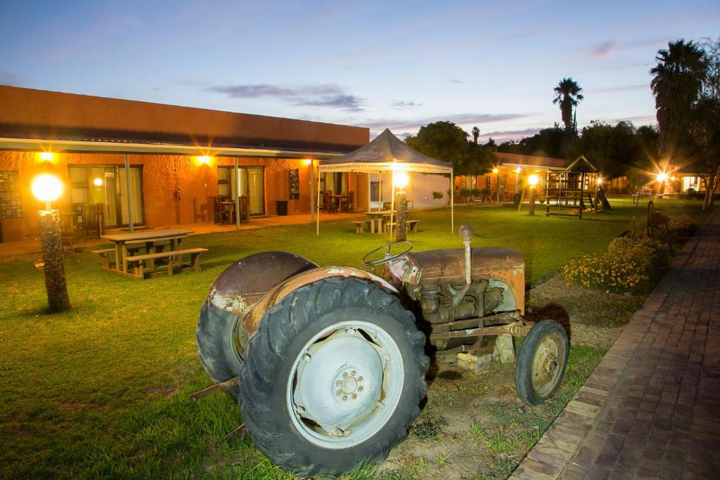 an old tractor parked in front of a building at Culdesac Guesthouse Oudtshoorn in Oudtshoorn