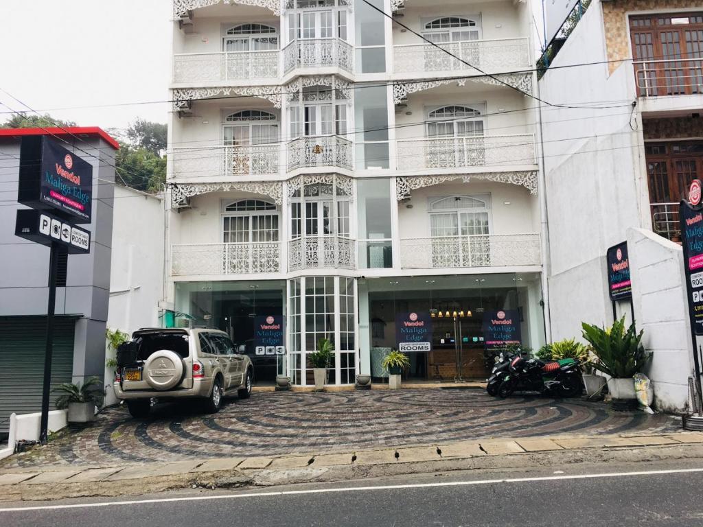a car parked in front of a building at Vendol Maliga Edge in Kandy