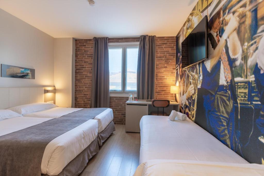 Posteľ alebo postele v izbe v ubytovaní Colectia Hotel Urumea
