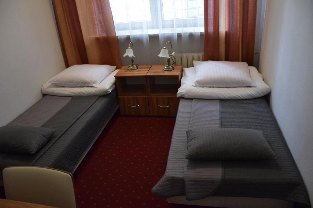 Mały pokój z 2 łóżkami i biurkiem w obiekcie Centrum Konferencyjne IBIB PAN w Warszawie