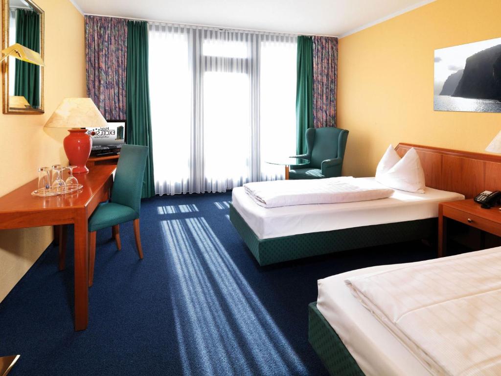 Postel nebo postele na pokoji v ubytování Hotel Excelsior Ludwigshafen