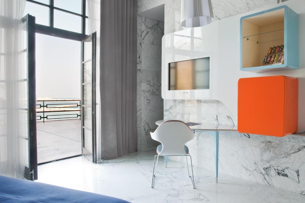 a bedroom with a desk and a chair at JR Hotels Bari Grande Albergo delle Nazioni in Bari