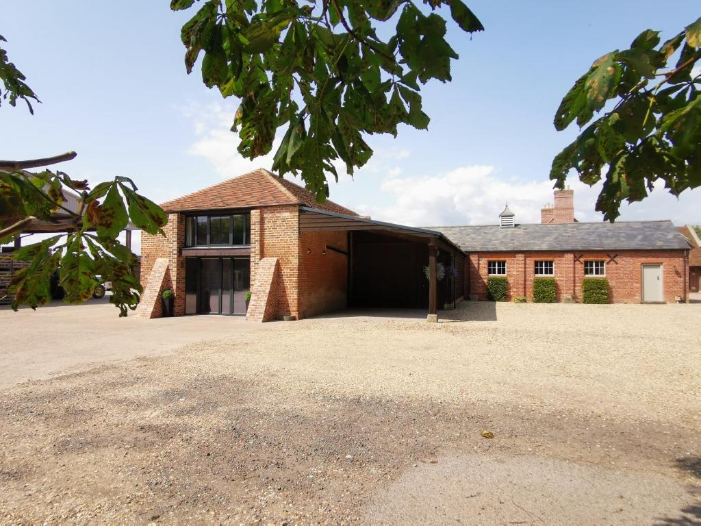 a large brick building with a large garage at Twitter Barn in Kirton