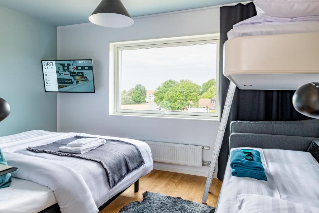 Postel nebo postele na pokoji v ubytování First Hotel Kokoloko