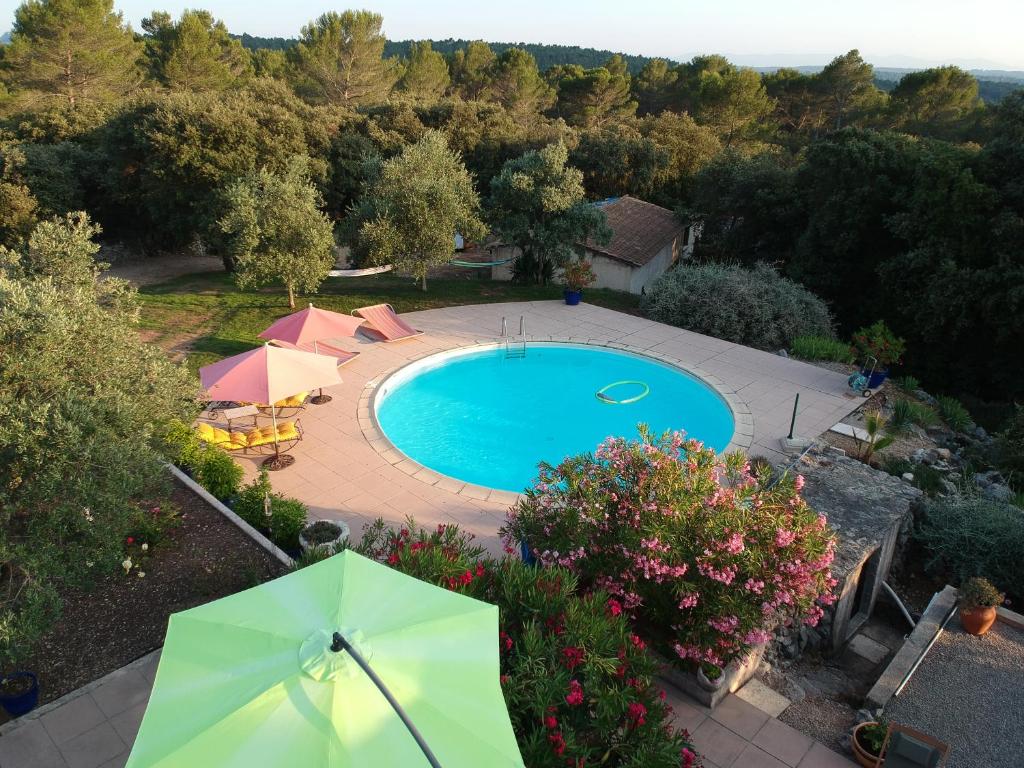 an overhead view of a swimming pool with an umbrella at Le Petit Coin de Paradis in Callas