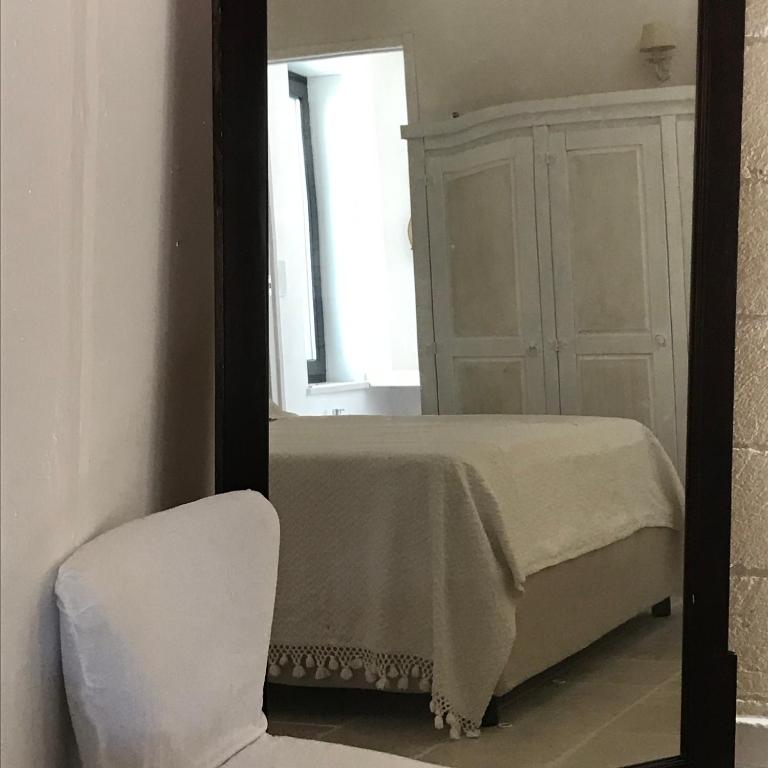 Łóżko lub łóżka w pokoju w obiekcie Relais Grottone