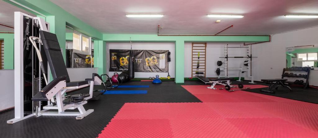 a gym with chairs and a red carpet at Corali Hotel in Tigaki