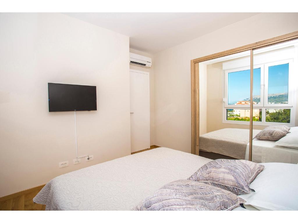 Postel nebo postele na pokoji v ubytování Uma Apartment