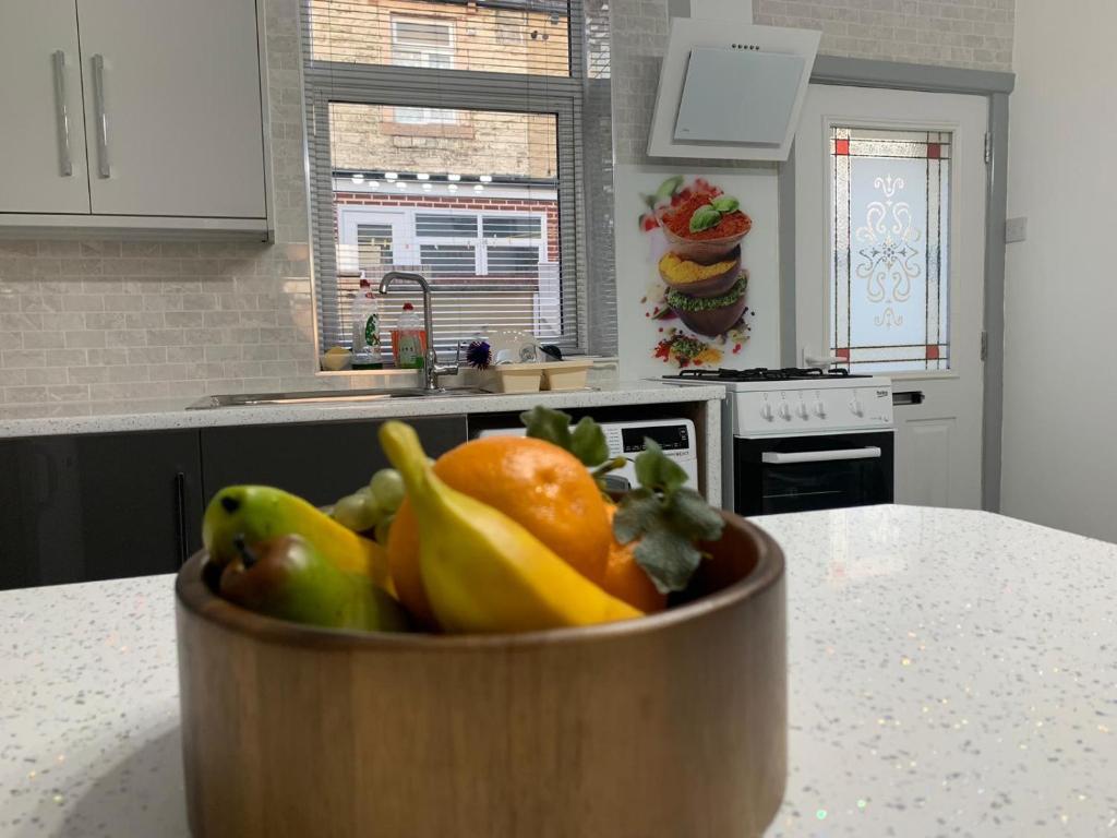 a bowl of fruit on a counter in a kitchen at Entire 6 Bed 5 Star Luxury House FREE WiFi nice views in Burnley