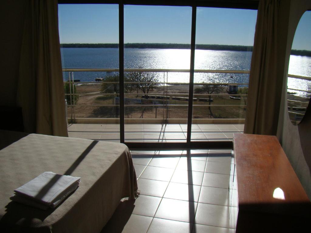 a bedroom with a bed and a view of the water at NorthBeach ::: Dpto. 7 in Colón