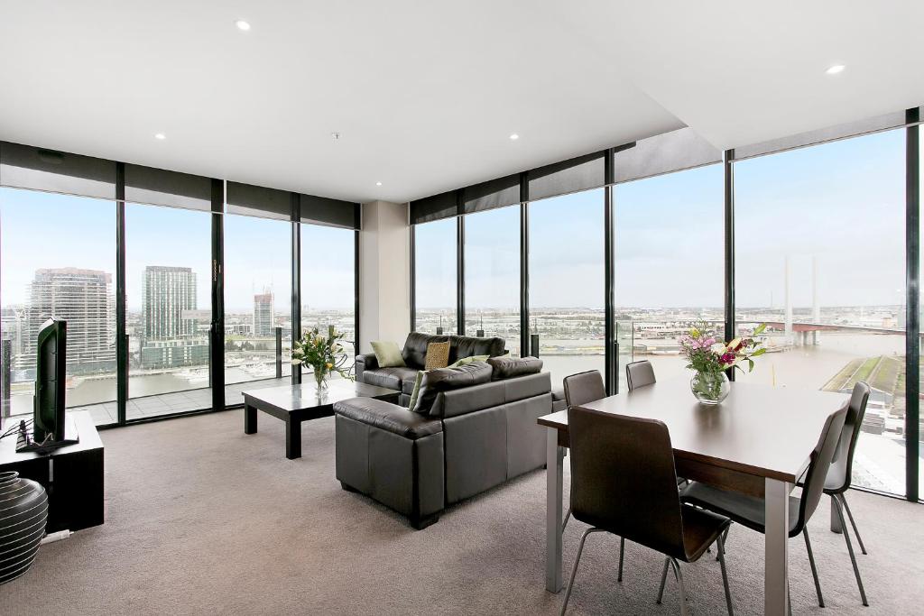 a living room with a couch and a table at Docklands Private Collection - NEWQUAY in Melbourne