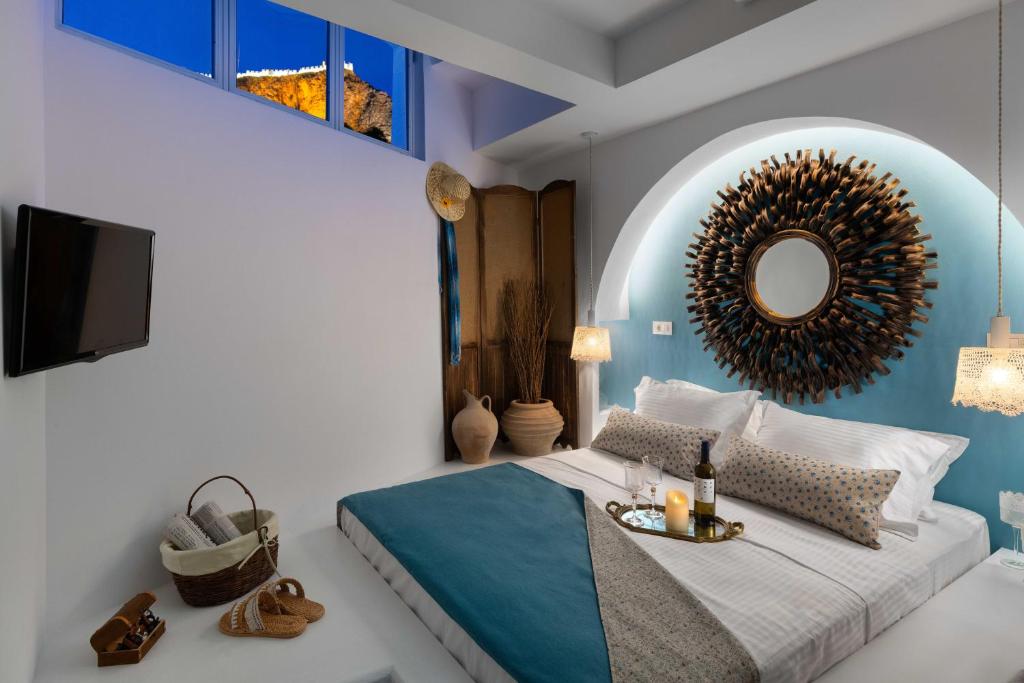 una camera con letto e specchio di Casa Pietra Lindos Luxury Traditional House a Líndos