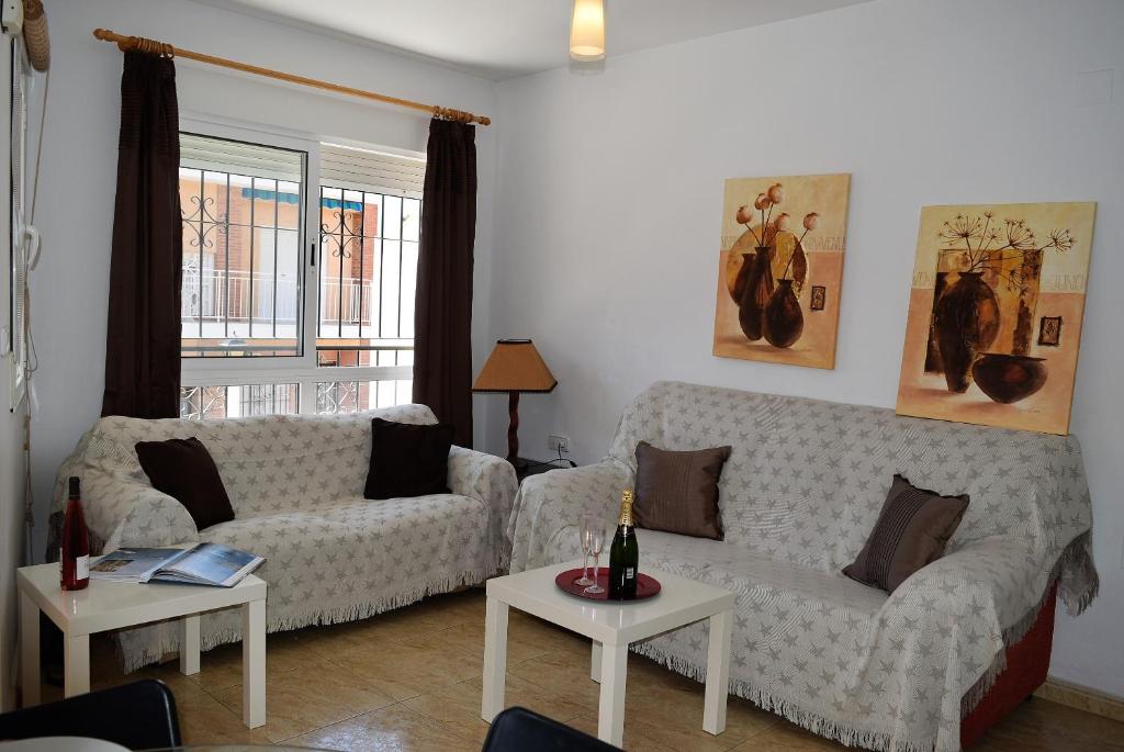 a living room with a couch and two tables at Mar Menor Lo Pagan Apartment in San Pedro del Pinatar