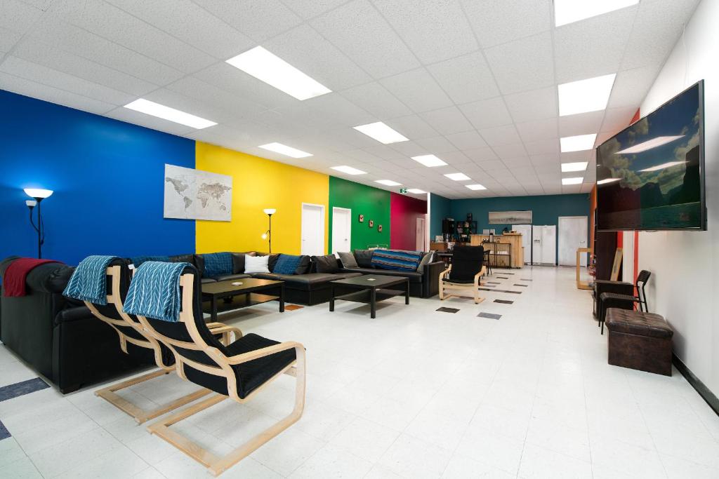 a waiting room with couches and chairs in a building at Out East Adventure Centre in Rocky Harbour