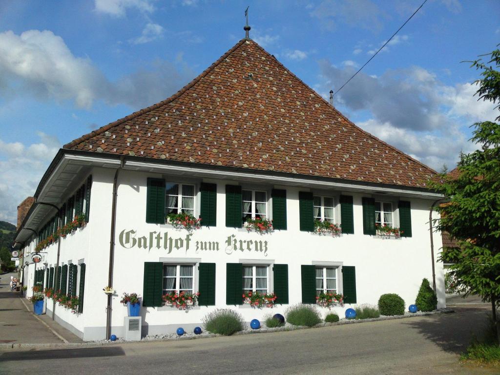 a white building with a brown roof at Hotel Kreuz in Holderbank