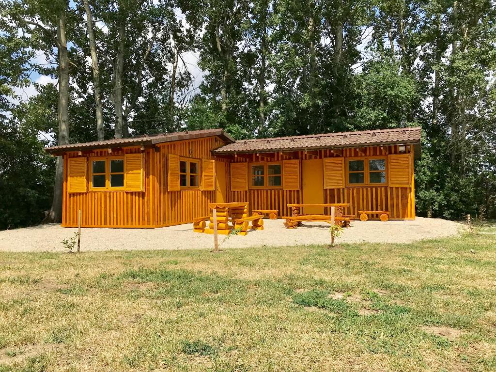 a wooden cabin with picnic tables in front of it at MiniPenzion Na Vyhlídce in Olomouc