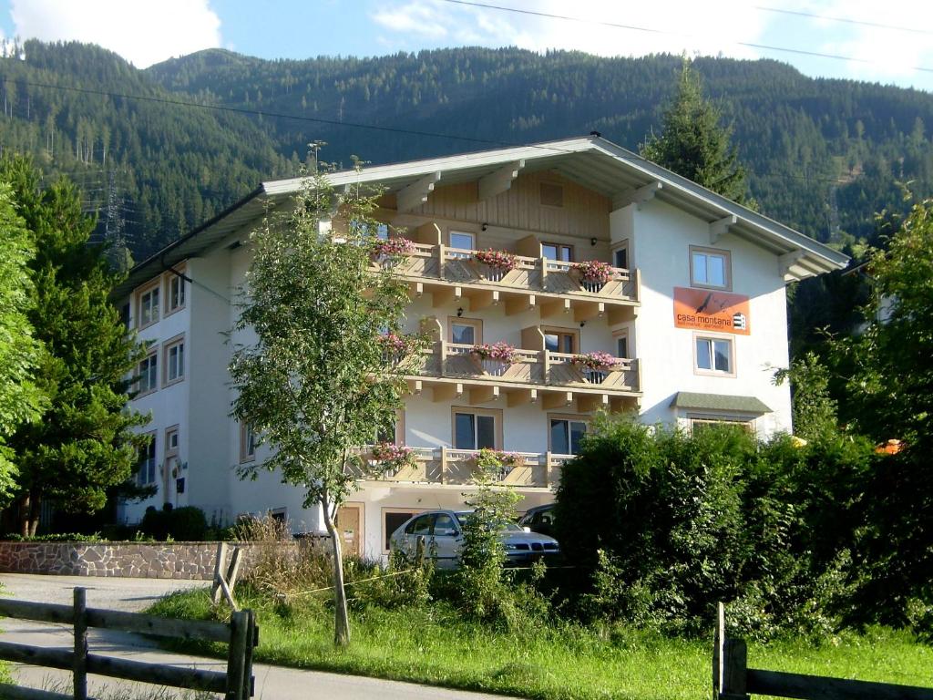 a large white building with a balcony at Casa Montana in Niedernsill