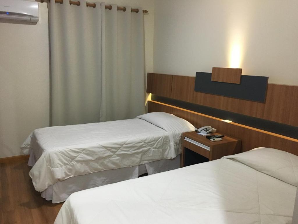 Postel nebo postele na pokoji v ubytování Hotel Aero Park e Estacionamento