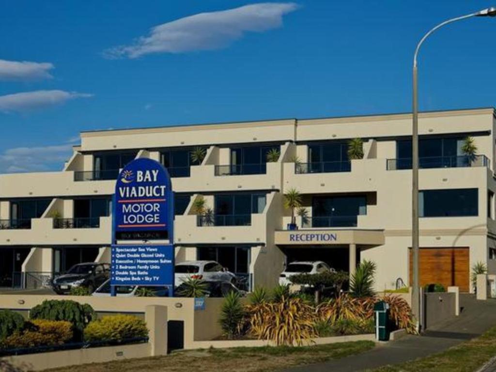 a building with a sign in front of it at Bay Viaduct Motor Lodge in Timaru
