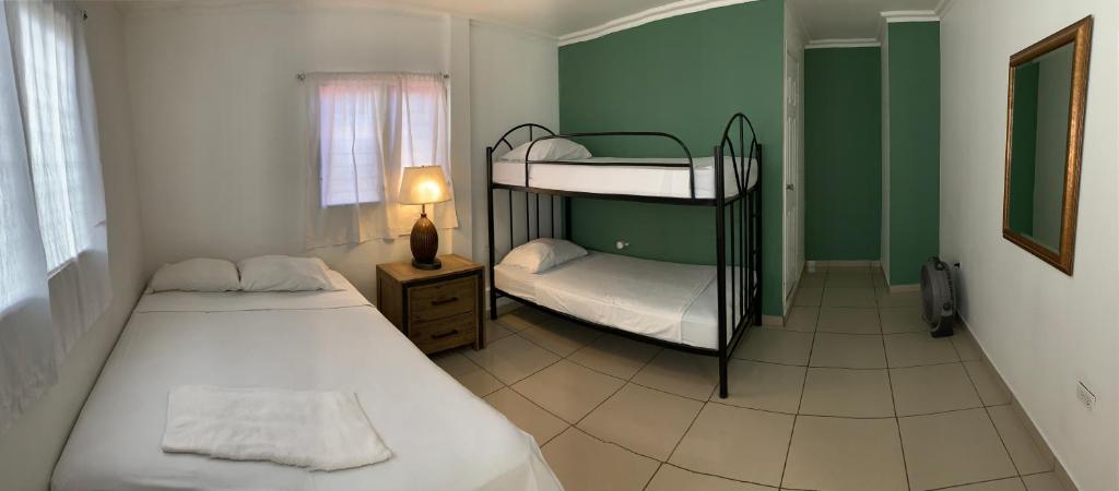 a bedroom with two bunk beds and a window at Palmira Hostel in Tegucigalpa