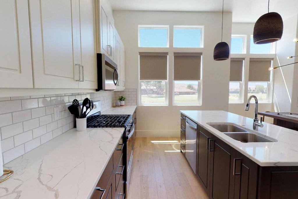 a kitchen with white cabinets and a sink at Villa #8 in St. George