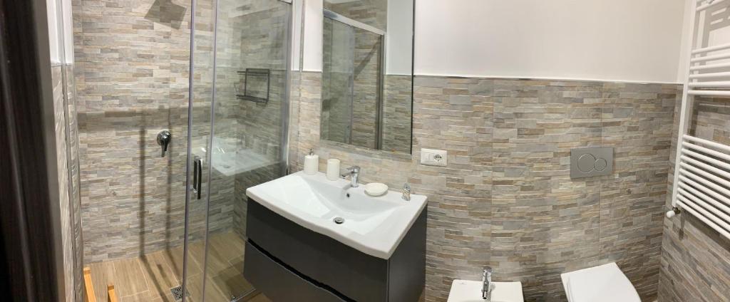 a bathroom with a sink and a shower at Cala Portavecchia in Monopoli