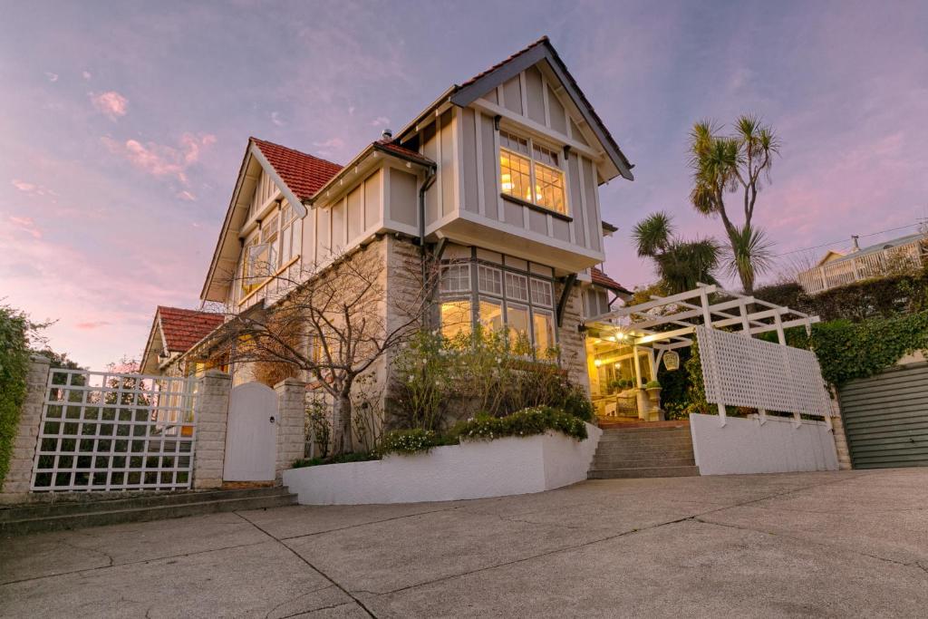 a house with a white fence in front of it at The Terrace in Oamaru